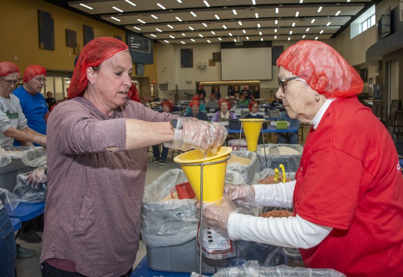 Megan Saulsbury and Gail Olive get to work adding items to the bags.